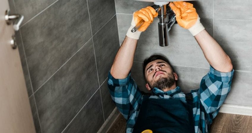 commercial plumber fixing water damage