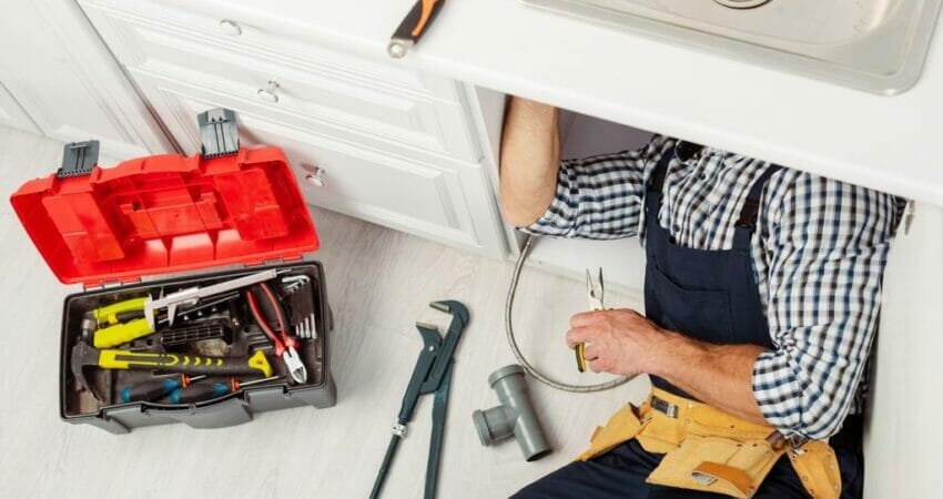 plumber fixing kitchen sink