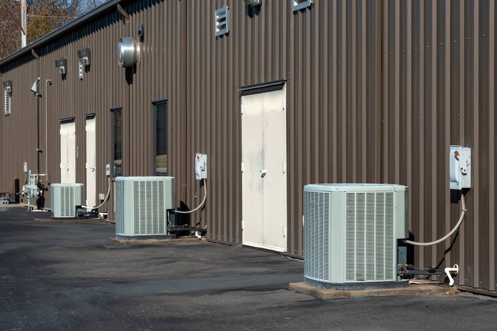 A row of generic air conditioner compressors