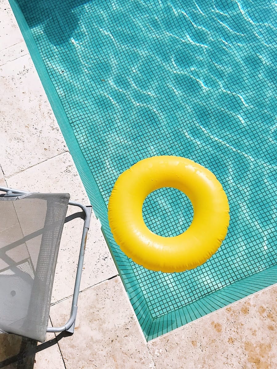 yellow plastic round toy on a swimming pool