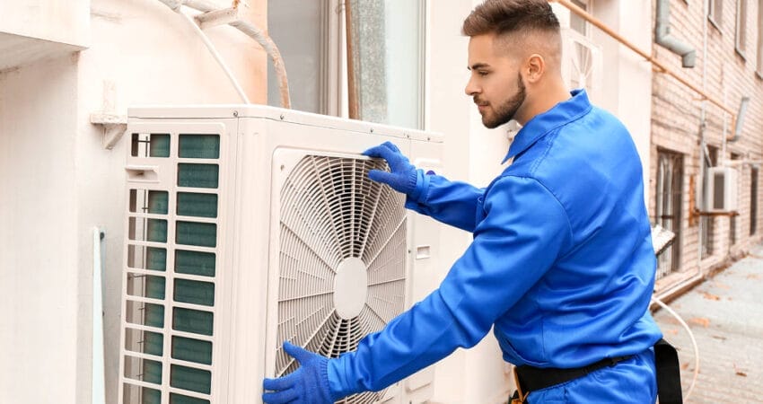 technician fixing airconditioner